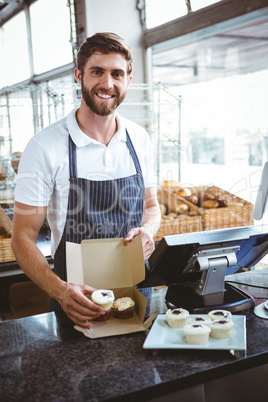 Smiling worker prepares orders