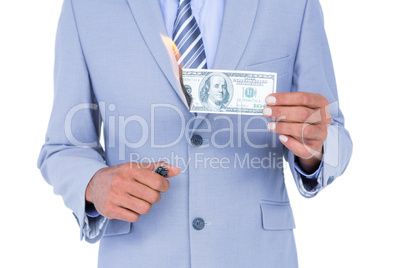 businessman burning a dollar banknote