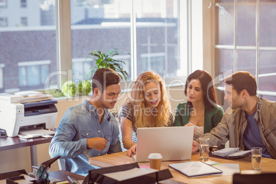 Group of young colleagues using laptop