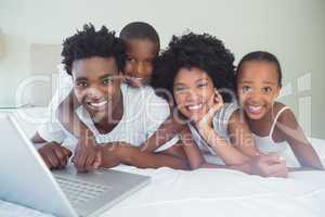 Happy family using the laptop together