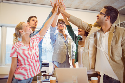 Happy business team doing hands checks