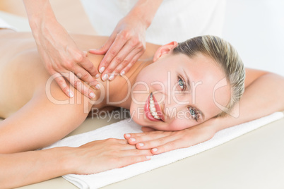 Pretty blonde enjoying a massage smiling at camera Pretty blonde enjoying a massage smiling at camera
