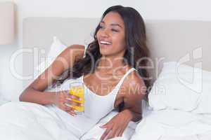 Relaxed woman drinking orange juice