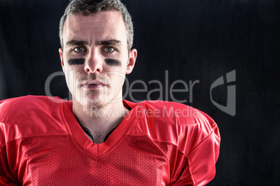 Portrait of a serious american football player looking at camera