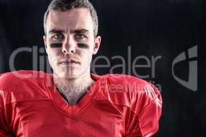 Portrait of a serious american football player looking at camera