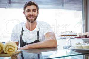 Smiling worker posing behind the counter