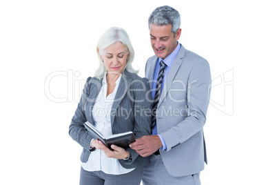 Smiling businesswoman and man with a notebook