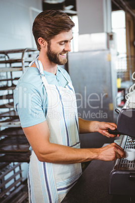 happy worker making coffee