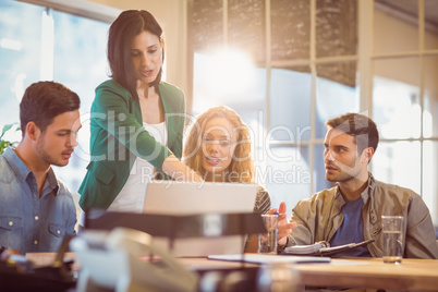 Group of young colleagues using laptop