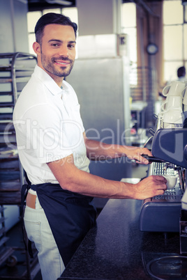 happy worker making coffee