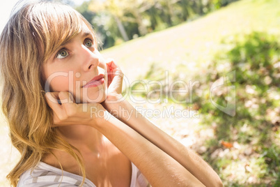 Smiling blonde relaxing in the grass