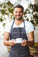 Handsome waiter smiling at camera