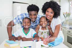 Happy parents helping children with homework