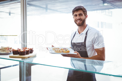 Smiling worker posing behind the counter