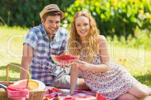 Young couple on a picnic holding watermelon