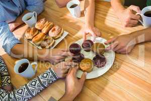 Business people taking cakes on table