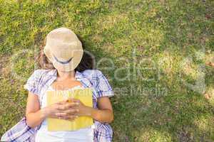 Pretty brunette resting in the grass