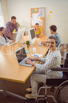 Creative casual businesswoman in wheelchair