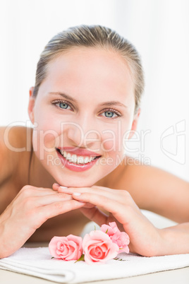 Peaceful blonde lying on towel smiling at camera Peaceful blonde lying on towel smiling at camera