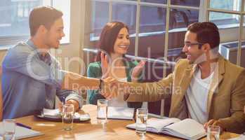 Business people shaking their hands