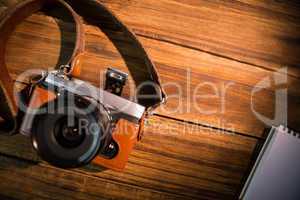 A beautiful fashioned camera next to the notepad