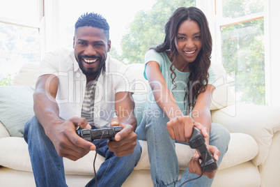 Happy couple on the couch playing video games
