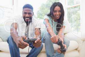 Happy couple on the couch playing video games