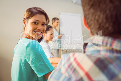 A young female designer listening to a conference