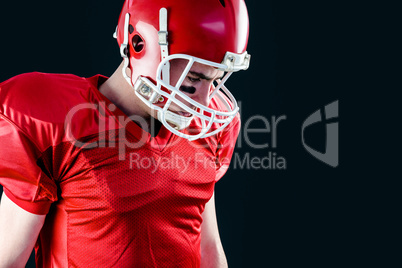 American football player taking his helmet on her head