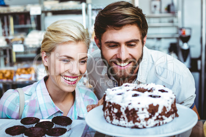 Cute couple on a date looking at a chocolate cake