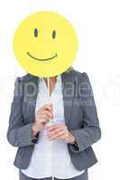 Businesswoman holding happy smiley face