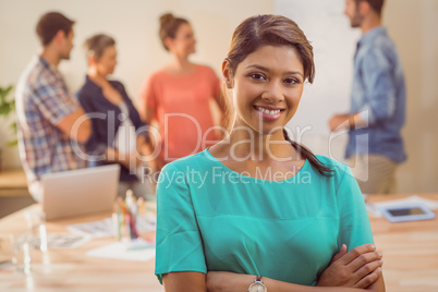 Young casual businesswoman smiling at camera