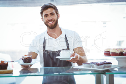 Smiling worker prepares breakfast