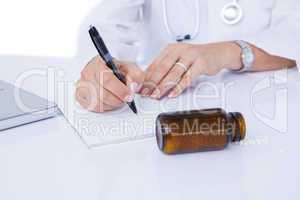 Doctor writing on a notepad