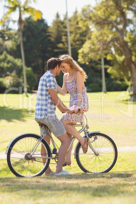 Young couple on a bike ride in the park