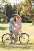 Young couple on a bike ride in the park