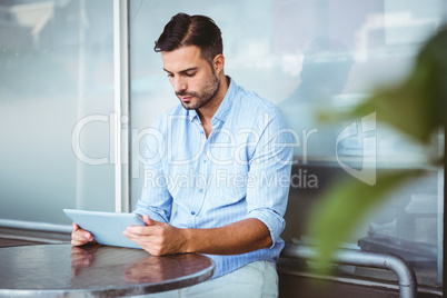 Attentive businessman using a tablet