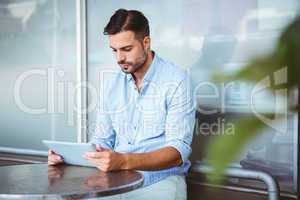 Attentive businessman using a tablet