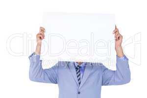 Portrait of a businessman hiding his face behind a blank panel