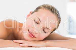 Beautiful young woman on massage table