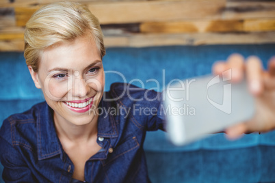 Smiling pretty blonde talking a selfie