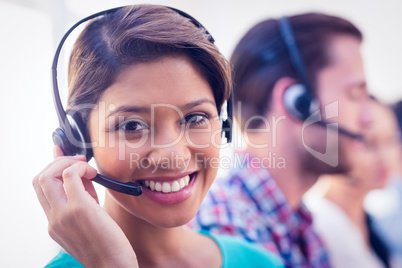 Pretty smiling businesswoman working in a call centre