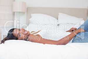 Relaxed woman lying on bed