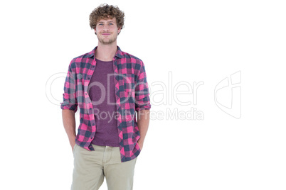 Happy handsome man looking at camera with hands in pocket