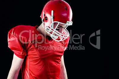 A football player taking his helmet on her head