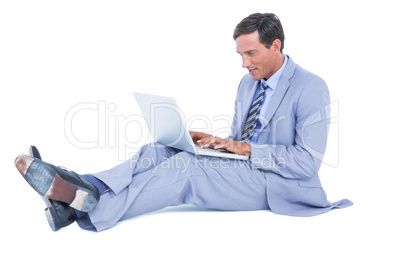 Handsome businessman sitting  using his laptop