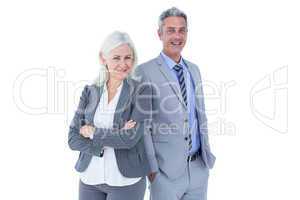 Smiling businesswoman and man with arms crossed