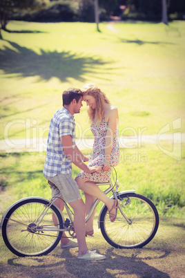 Cute couple on a bike ride in the park