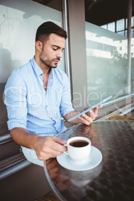 Attentive businessman using a tablet