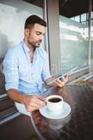 Attentive businessman using a tablet